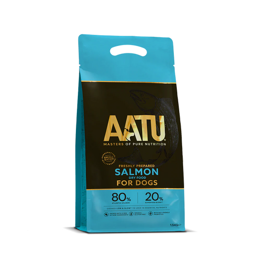There is a bag of AATU Salmon Dry Dog Food. It is a front view of the packaging and the bag is blue with a dark band in the middle. The wording AATU is embellished in gold font on the front of the bag with the tag line 'Masters of pure nutrition'. The bag has a little handle at the top and it is marked as a 1.5kg bag.