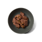 Top view of Dinky Dog Turkey & Pheasant wet dog food in a bowl, showcasing grain-free recipe with visible meat and vegetables.