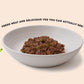 Bowl of Dinky Dog Lamb & Apple wet dog food showing visible meat and vegetables, ideal for small breed dogs with fussy appetites.